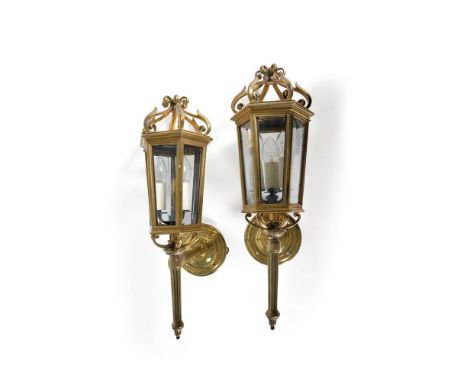 A pair of gilt metal and glazed hexagonal wall lanterns in George III taste, second half 20th century, the finials each compr