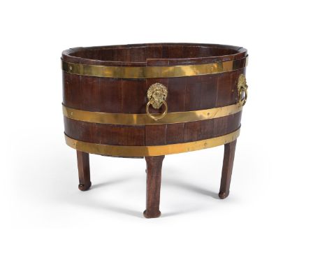 A George III mahogany and brass bound wine cooler, late 18th century, of oval coopered form with gilt-brass lion mask, ring h