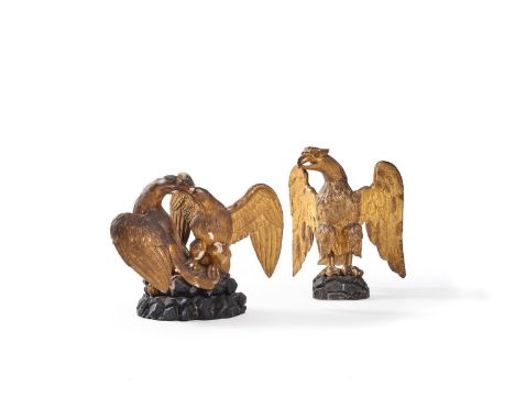 A carved and giltwood model of a spreadeagle, 19th century, head to dexter, standing on a rockwork base, 41cm high, 35cm wide