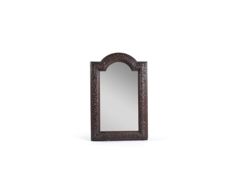 A Louis XIV carved boxwood framed mirror, late 17th century, with an associated plate, within an arched and moulded foliate c