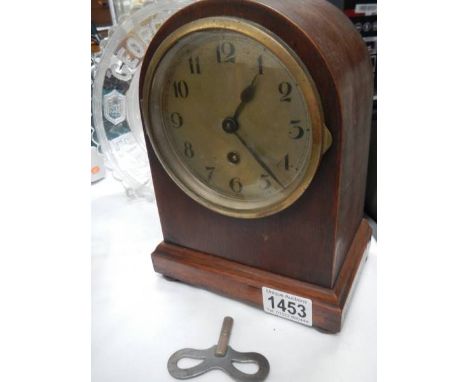 A mahogany cased mantel clock in working order.