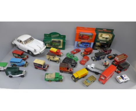 A collection of die-cast model vehicles, mainly advertising vans and a Burago Porsche 