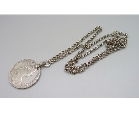 A mounted Marie Theresia silver coin on white metal chain 