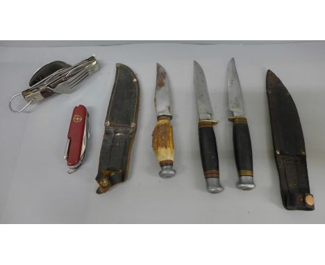 Three hunting knives, one by William Rodgers, and two multi-tool knives 
