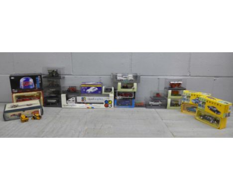 A box of die-cast model vehicles, boxed, including Quadgraphics 1/64 scale Peterbilt 387 