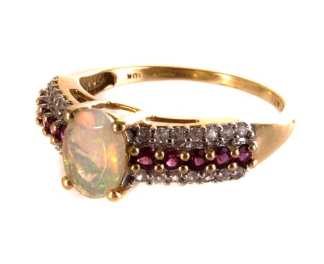 A 9ct gold opal, ruby and diamond dress ring, the central opal flanked by a single row of rubies and two rows of diamonds, al