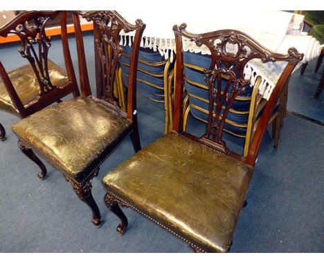 A set of four late 19th century Chippendale revival dining chairs, with cupid's bow top rails over pierced splat, surmounting