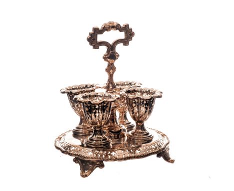 A Victorian silver plated egg water, having pierced tray base on scroll supports with handle and four egg cups (5)