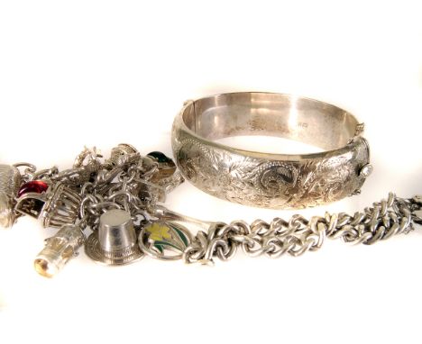 A silver Charm bracelet,  comprising of multiple charms, together with a silver bangle with floral swag engraved top and a pa