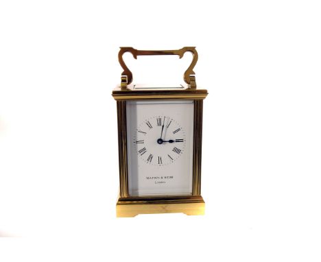 A Mappin & Webb brass carriage clock, having black Roman numerals to white face, also with manufacturers name, with bevelled 