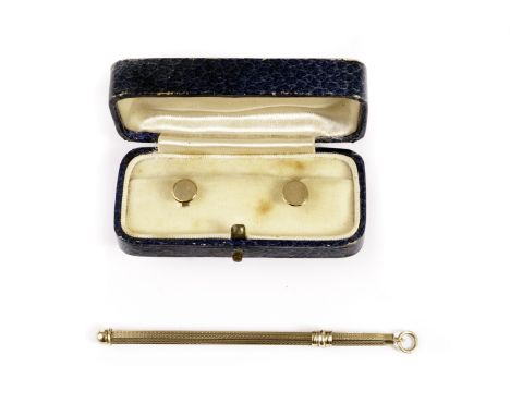 A 9ct gold swizzle stick and pair of dress studs, having hexagonal barrel with engine turned design, hallmarked, the studs in