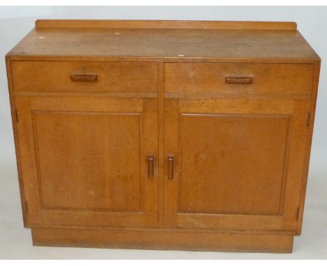 An Arts & Crafts Heal & Son light oak sideboardHaving two drawers and two panelled cupboard doors, height 91cm, length 122cm.