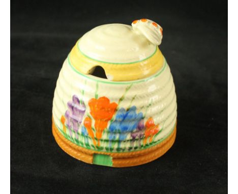 A Clarice Cliff Newport pottery Beehive honey potDecorated in the 'Crocus' pattern, factory marks to base, height 10cm   COND