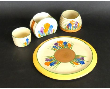 Four pieces of Clarice Cliff CrocusComprising teapot stand, diameter 16cm, bonjour shaped bowl, height 6.5cm, honey pot (lack