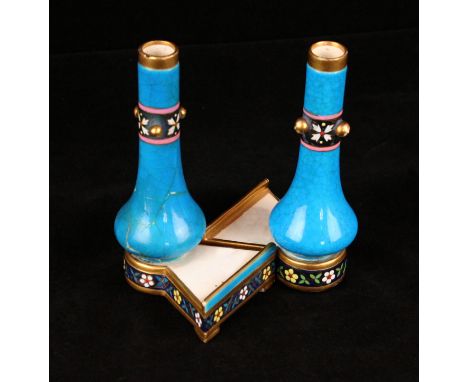 A pair of Minton turquoise glazed vases in the manner of Dr. Christopher DresserOf baluster form, raised on triangular shaped