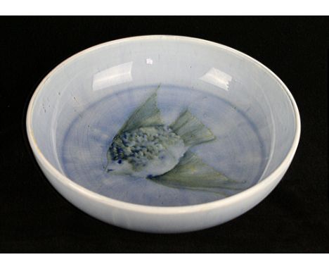 A Walter Moorcroft pottery bowlDecorated with a fish to centre on a light blue ground, impressed factory marks and signature 