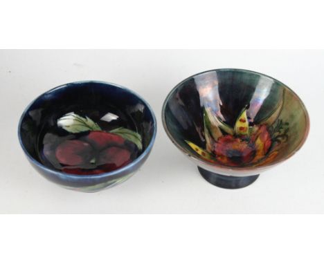 Two Walter Moorcroft pedestal bowlsTo include a conical example decorated in the 'Orchid' pattern on a flambe ground, height 