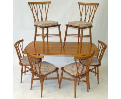 A Mid Century Ercol light elm dining suiteComprising refectory table, height 70cm, length 133cm, six spindle back 'Stacking' 