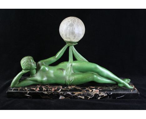 Pierre Le Faguays (1892-1962) Art Deco patinated spelter lampModelled in the form of a semi nude reclining lady supporting th