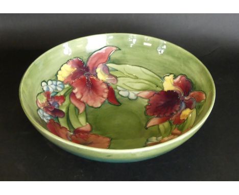 A Walter Moorcroft bowl of circular formDecorated in the 'Orchid' pattern on a green ground, height 9.5cm, diameter 31cm    C