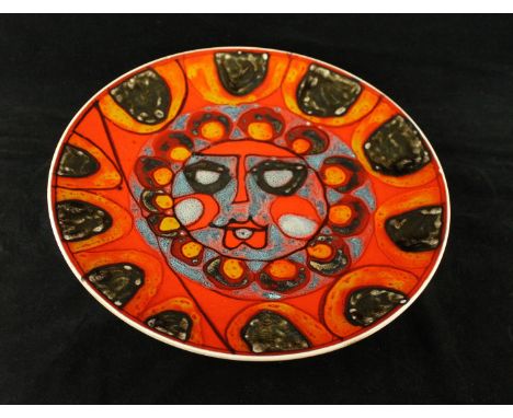 A Poole Pottery Delphis wall chargerDecoration with a central Sun Face surrounded by multi-coloured stylised motifs, black pr