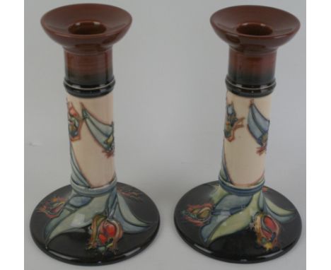 A pair of modern Moorcroft candlesticksDecorated in the 'Red Tulip' pattern, factory marks to base, height 21cm    CONDITION 