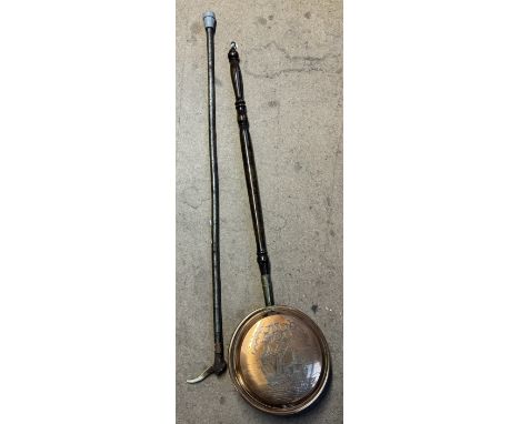 An antler handled walking stick together with another walking stick and a bed warming pan