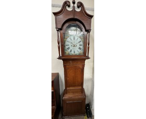 A 19th century oak longcase clock the hood with a broken swan neck pediment and turned columns, above a short trunk door, box