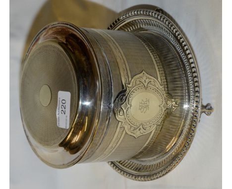 Silver plated biscuit tin on stand with ball and claw feet and engine turned decoration 
