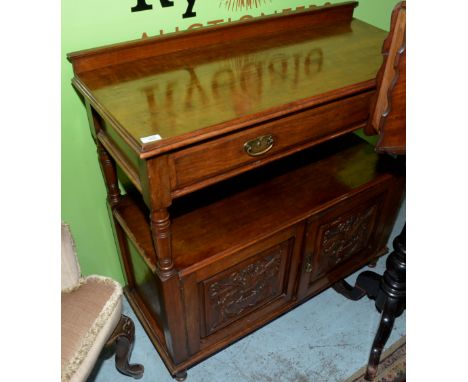 Mahogany buffet with drawers above open centre and two carved panelled doors 