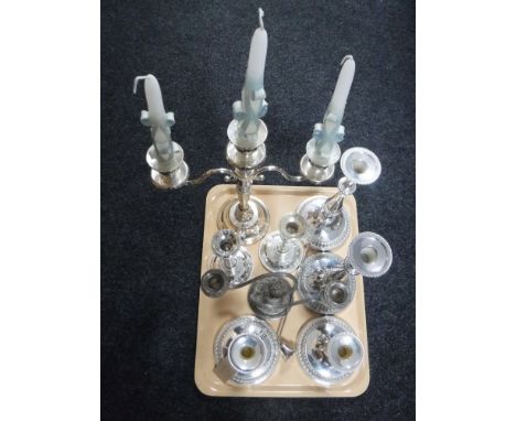 A tray containing two silver plated candelabrum together with three pairs of silver plated candlestick and a candle snuffer
