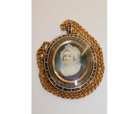 A fine quality Georgian gold memorial pendant, the rose-coloured frame with blue and white enamel, with a braid of hair aroun