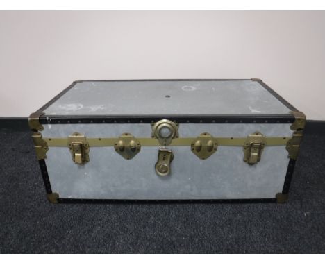 A tailors dummy and a metal shipping trunk 