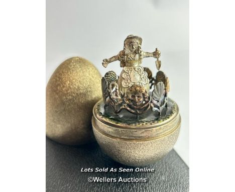 A hallmarked silver gilt egg Stuart Devlin, London 1973, nursery rhyme collection. Opening to reveal a miniature figure of Ma