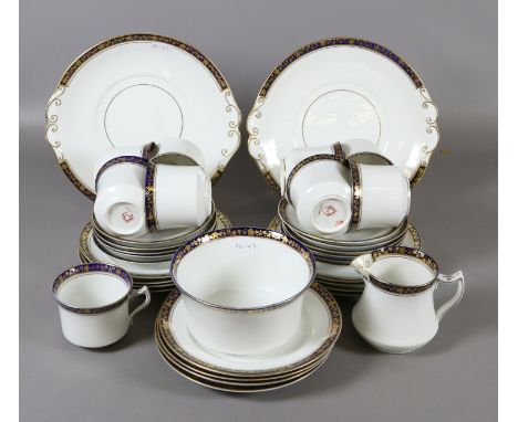 A Diamond china part tea service including sandwich plates, milk jug, slop bowl, cups and saucers etc hand painted with gilt 