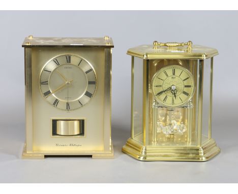 A Seiko quartz mantel clock with Westminster chime, a similar brass cased anniversary clock and original receipt.