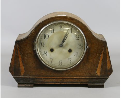 An Art Deco oak cased eight day mantel clock.