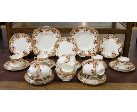 An Edwardian Paragon china tea service decorated with flowers and gilt edges, approximately forty pieces.
