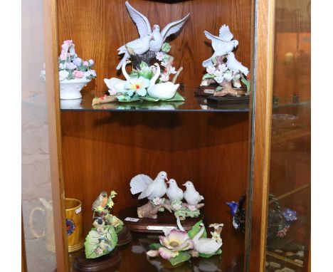 A collection of doves, birds and ceramic swans by Leonardo and Capodimonte.
