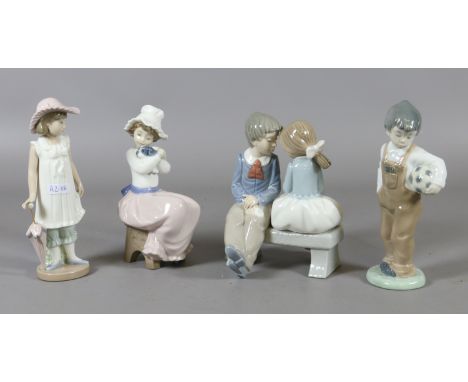 Four Nao figurines of children in various poses.