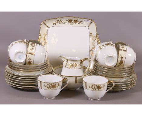 A Noritake china tea service decorated with gilt decoration including a sandwich plate, milk jug, sugar bowl, cups and saucer