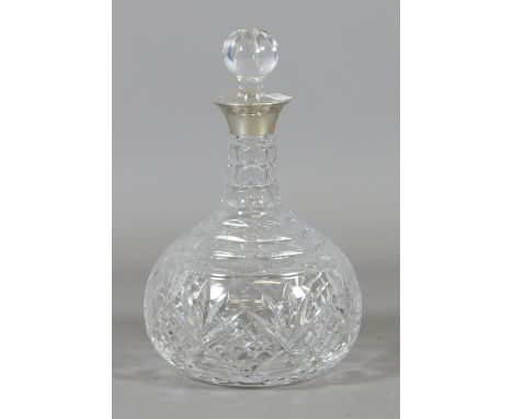 A cut glass hallmarked silver topped decanter with stopper.