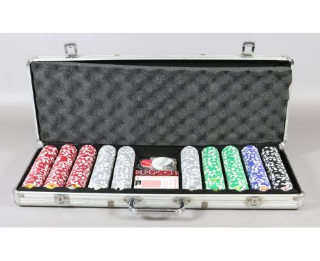 A cased Poker set to include chips, dice, dealer and blind counters and a set of playing cards.