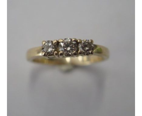 A yellow gold 3 stone diamond ring, centre stone approx 0.20ct, size Q, not hallmarked but tests to approx 14ct, approx 3 gra