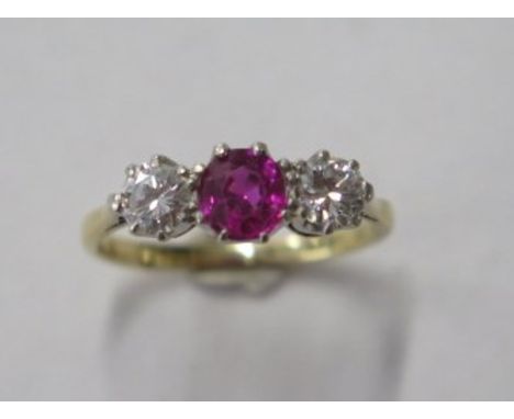 An 18ct gold and platinum three stone diamond and ruby / spinnel ring, diamonds approx 0.20ct each, size K/L, approx 2.6 gram