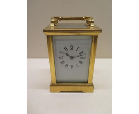 A brass French 8 day carriage clock, 13cm tall, glass good, running with key 
