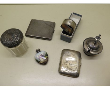3 silver cigarette cases, a silver top bottle, a silver pepper, serviette ring and a porcelain scent bottle with silver top, 