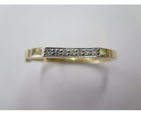 A 14K yellow gold diamond hinged hollow bangle, approx 12.3 grams, internal 5.5cm x 4.8cm, in good condition 