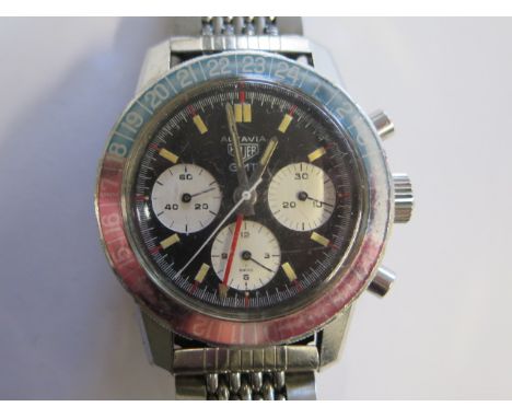 A Heuer Autavia GMT gents stainless steel bracelet manual wind chronograph wristwatch with blue and red bezel, dual timezone,