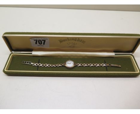 A manual wind 9ct ladies wristwatch on plated strap, running, 15mm case, approx total weight 10 grams 